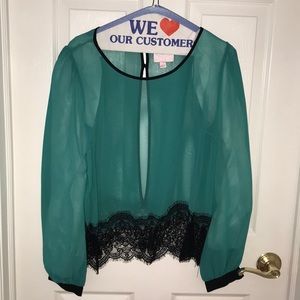 Emerald green split back blouse with lace trim